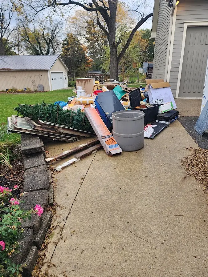 Dumpster being loaded with debris for Estate Cleanout Dumpster Rental in Tillamook